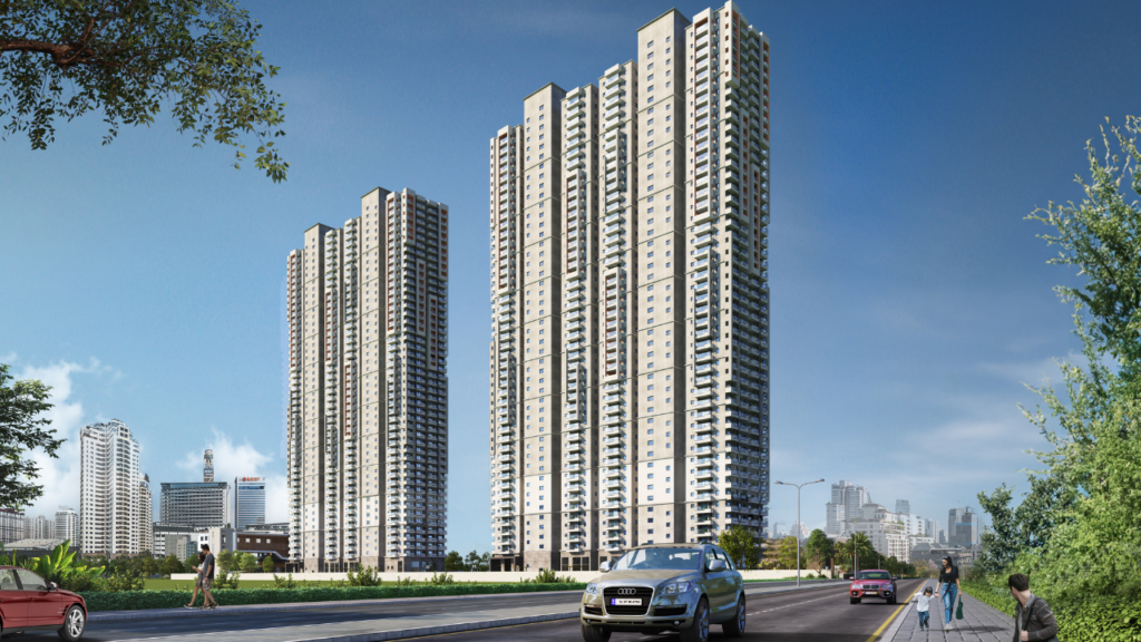 A wide photo of a large gated community with twin multi-story towers on a sunny day, viewed from a roadside perspective with an SUV driving by.
