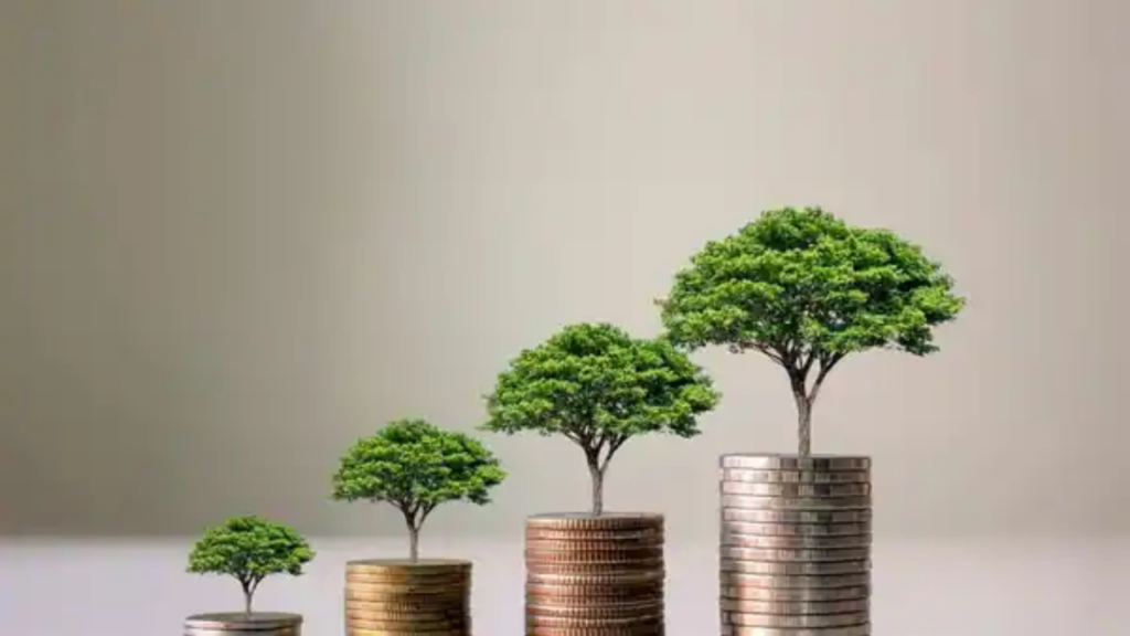 Small green trees growing out of four stacks of coins that increase in height.
